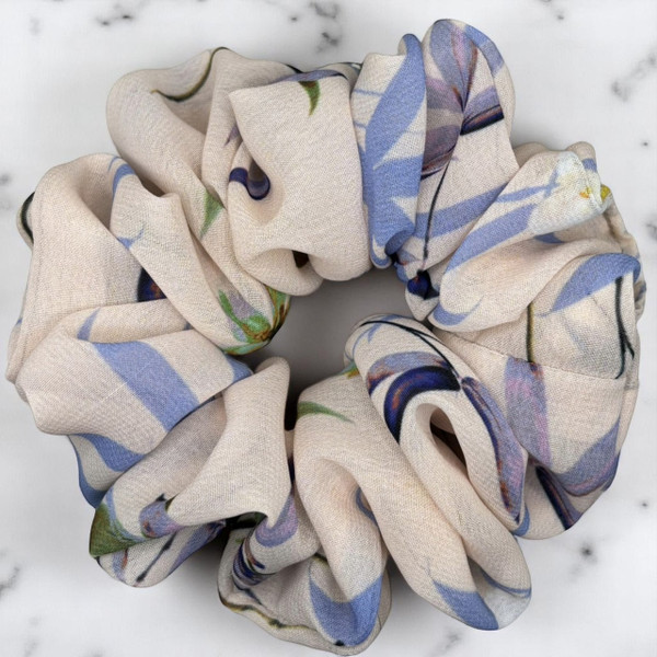 Tuhil Threads Large Floral Print Scrunchie. Charming large hair tie with a beautiful multi-colour floral design, offering a stylish and gentle hold. Shop Tuhil Threads hair accessories.