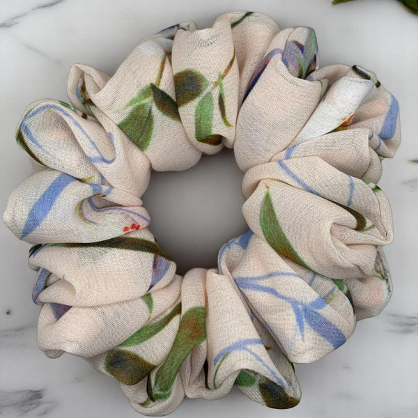Tuhil Threads Medium Floral Print Scrunchie. Charming medium hair tie with a beautiful multi-colour floral design, offering a stylish and gentle hold. Shop Tuhil Threads hair accessories.