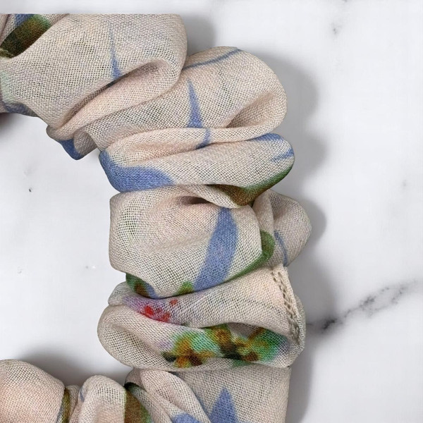 Tuhil Threads Small Floral Print Scrunchie. Charming small hair tie with a beautiful multi-colour floral design, offering a stylish and gentle hold. Shop Tuhil Threads hair accessories.
