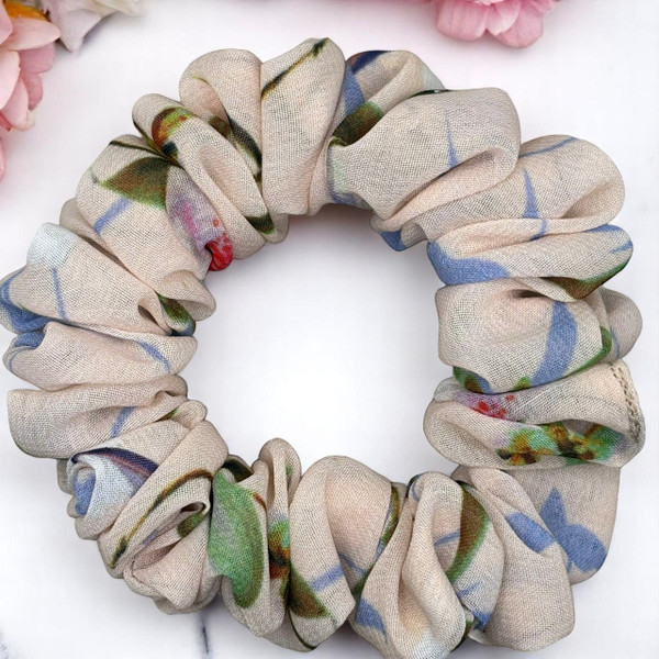 Tuhil Threads Small Floral Print Scrunchie. Charming small hair tie with a beautiful multi-colour floral design, offering a stylish and gentle hold. Shop Tuhil Threads hair accessories.