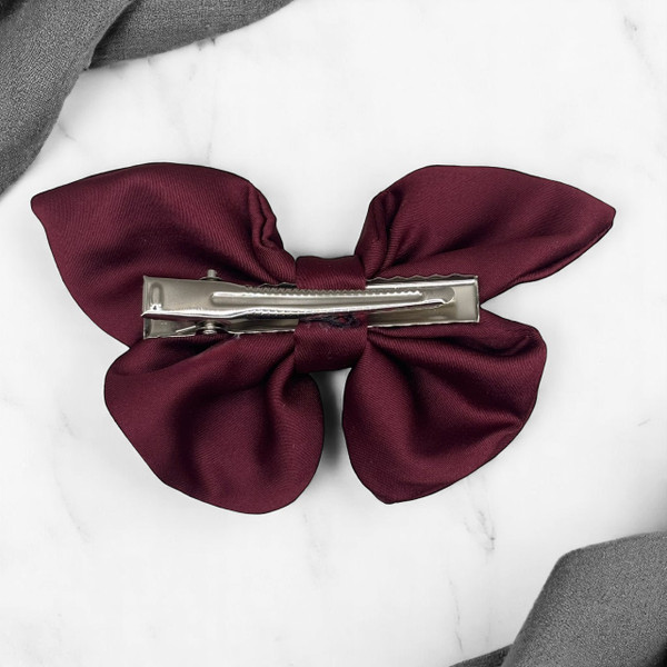 Tuhil Threads small burgundy Royal Micro Satin butterfly bow (10x6cm) showcasing its elegant shape and rich colour. Shop Tuhil Threads hair accessories.