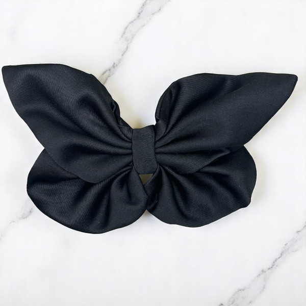 Tuhil Threads medium black Royal Micro Satin butterfly bow (12x8cm) showcasing its deep classic colour and elegant, bold shape. Shop Tuhil Threads hair accessories.