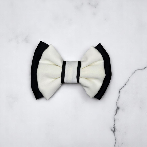 Tuhil Threads Small Royal Micro Satin Classic Bow in a two-tone design with a bold black bottom layer and a cream top layer, neatly tied. Shop Tuhil Threads hair accessories.
