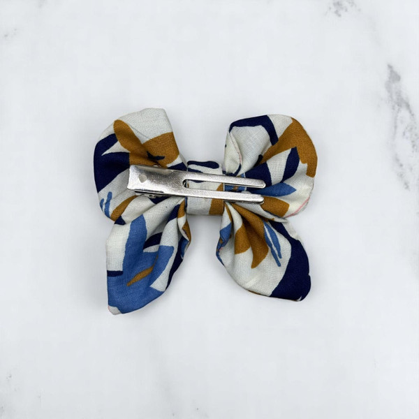 A stylish Abstract Floral Print Small Polycotton Butterfly Bow by Tuhil Threads, measuring approximately 10cm wide by 6cm high. Shop Tuhil Threads hair accessories.