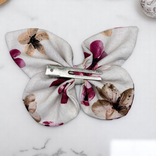An elegant Dusty Blossom Floral Medium Cotton Butterfly Bow by Tuhil Threads, measuring approximately 12cm wide by 8cm high. Shop Tuhil Threads hair accessories. An elegant Dusty Blossom Floral Medium Cotton Butterfly Bow by Tuhil Threads, measuring approximately 12cm wide by 8cm high. Shop Tuhil Threads hair accessories.
