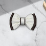 Tuhil Threads Small Royal Micro Satin Classic Bow in a two-tone design with a taupe bottom layer and a cream top layer, neatly tied. Shop Tuhil Threads hair accessories.