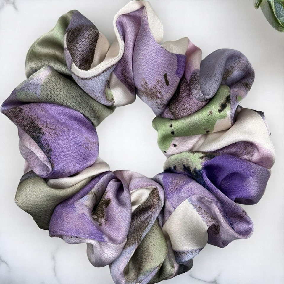 Tuhil Threads Medium Cool Tone Abstract Silky Satin Scrunchie. Smooth and lustrous medium silky satin hair tie featuring a beautiful abstract design in cool purple and green hues for a sophisticated, gentle hold. Shop Tuhil Threads hair accessories.