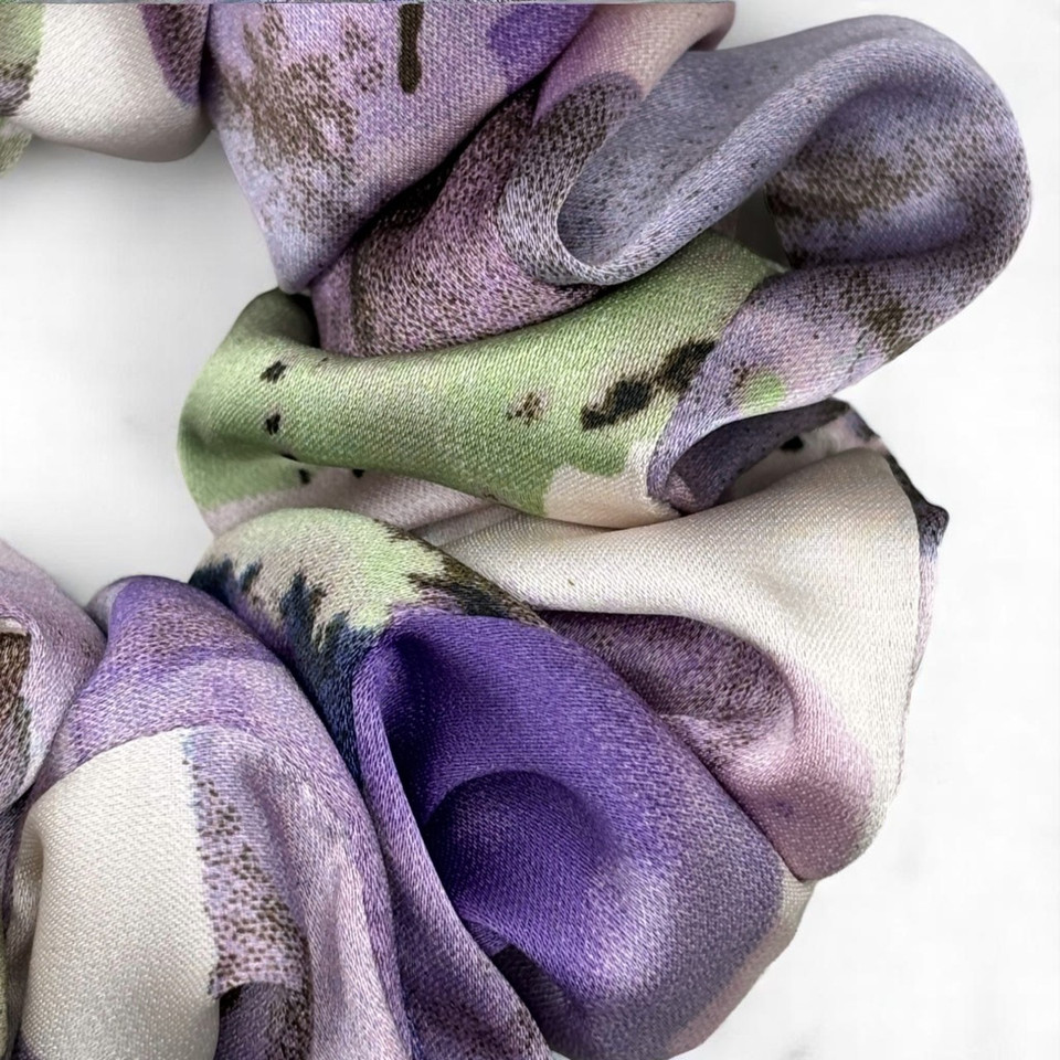 Tuhil Threads Medium Cool Tone Abstract Silky Satin Scrunchie. Smooth and lustrous medium silky satin hair tie featuring a beautiful abstract design in cool purple and green hues for a sophisticated, gentle hold. Shop Tuhil Threads hair accessories.