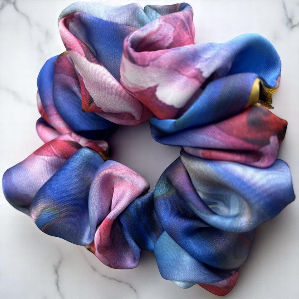Tuhil Threads Large Vibrant Abstract Silky Satin Scrunchie. Luxurious large silky satin hair tie with a stunning abstract watercolor blend of rich blues, pinks, and purples for an eye-catching, gentle hold. Shop Tuhil Threads hair accessories.