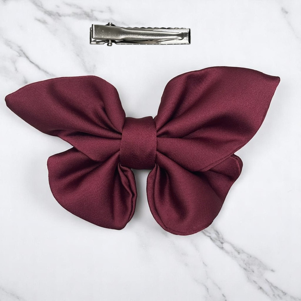 Tuhil Threads small burgundy Royal Micro Satin butterfly bow (10x6cm) showcasing its elegant shape and rich colour. Shop Tuhil Threads hair accessories.