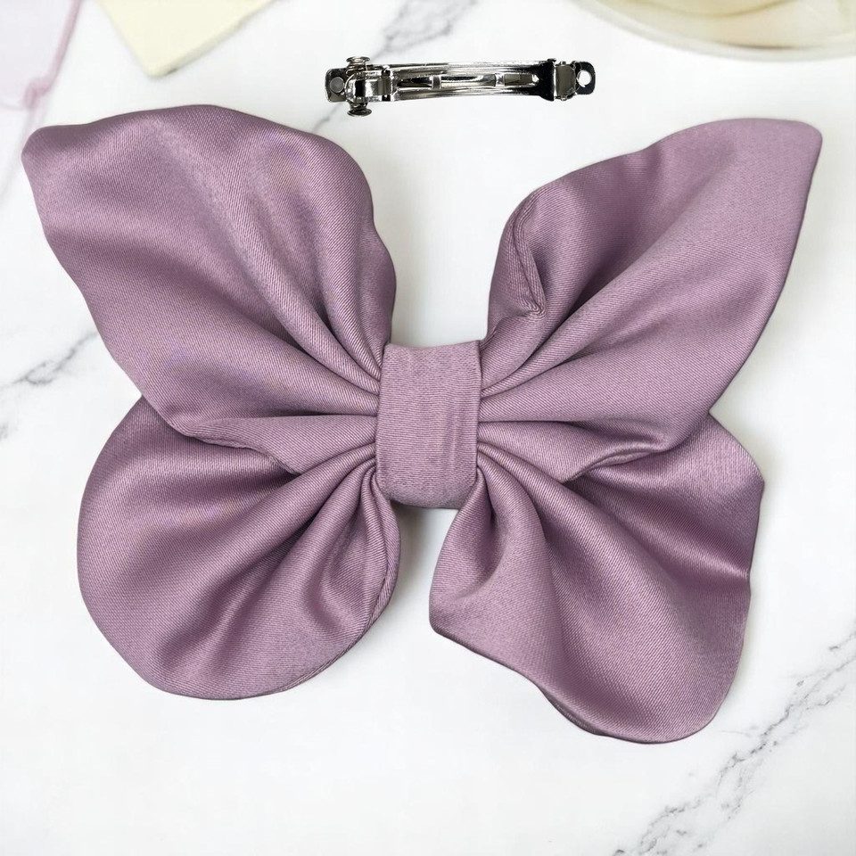 Tuhil Threads medium lilac Royal Micro Satin butterfly bow showcasing its rich, deep colour and elegant shape. Shop Tuhil Threads hair accessories.