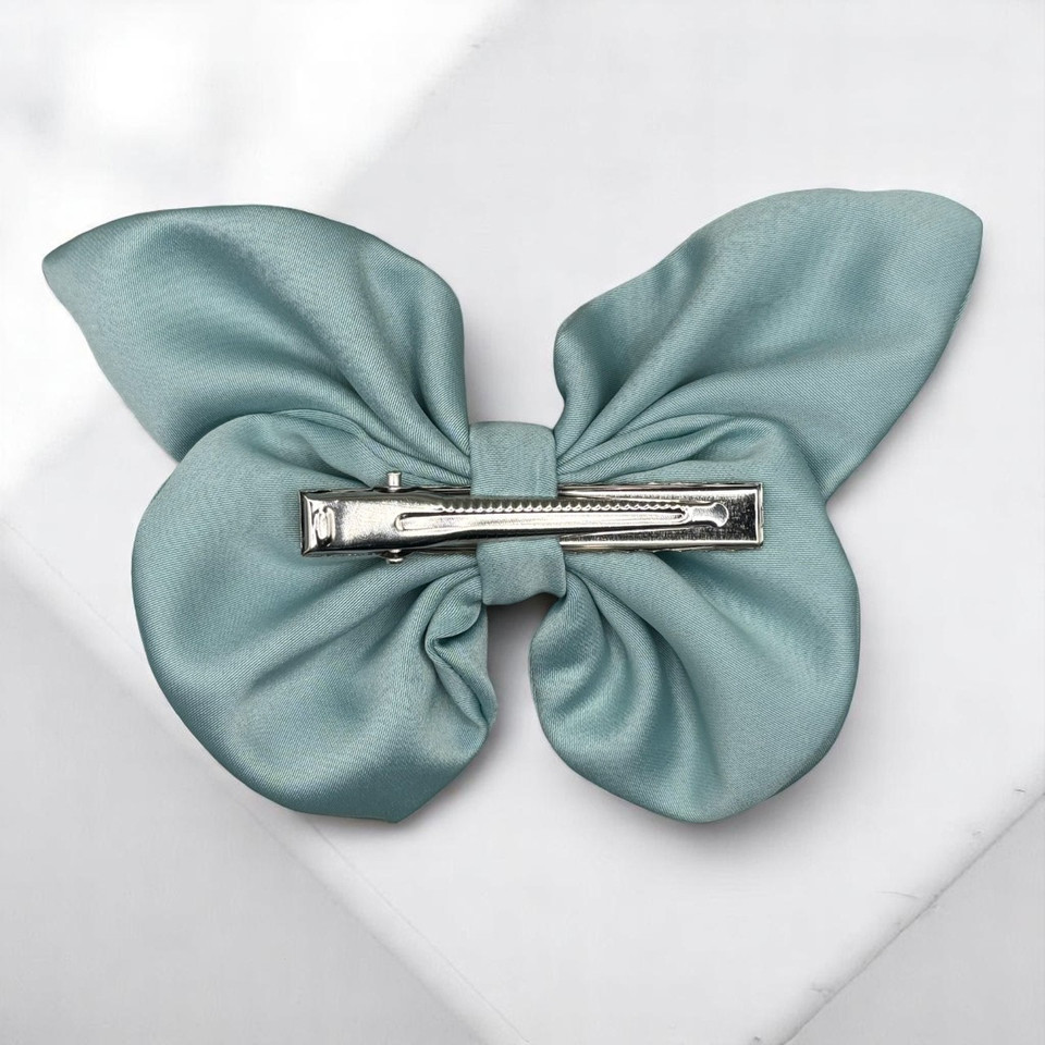 Tuhil Threads medium mint green Royal Micro Satin butterfly bow showcasing its fresh pastel colour and elegant shape. Shop Tuhil Threads hair accessories.