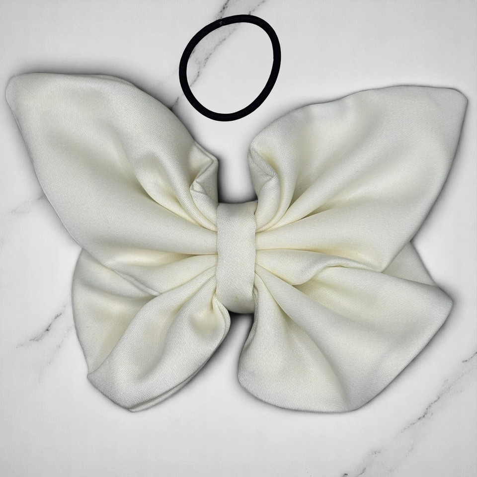 Tuhil Threads medium cream Royal Micro Satin butterfly bow (12x8cm) showcasing its soft neutral colour and elegant, graceful shape. Shop Tuhil Threads hair accessories.