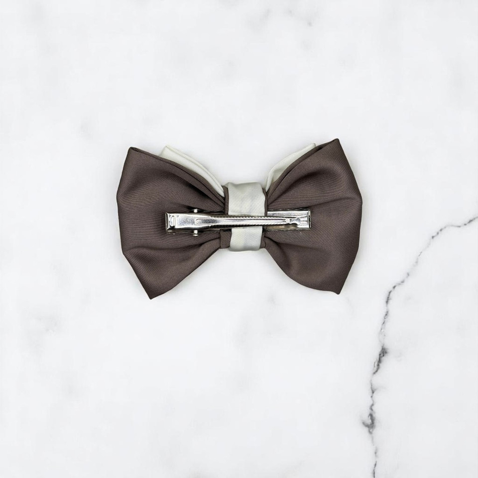 Tuhil Threads Small Royal Micro Satin Classic Bow in a two-tone design with a taupe bottom layer and a cream top layer, neatly tied. Shop Tuhil Threads hair accessories.