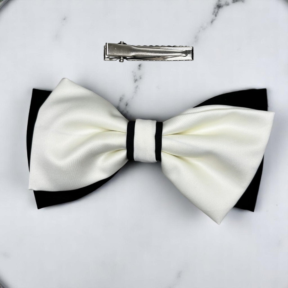 Tuhil Threads Large Royal Micro Satin Classic Bow in a two-tone design with a bold black bottom layer and a cream top layer, neatly tied, measuring 17x10cm. Shop Tuhil Threads hair accessories.