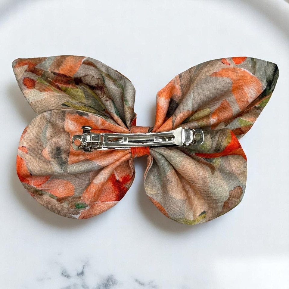 A vibrant Coral Bloom Floral Medium Cotton Butterfly Bow by Tuhil Threads, measuring approximately 12cm wide by 8cm high. Shop Tuhil Threads hair accessories.