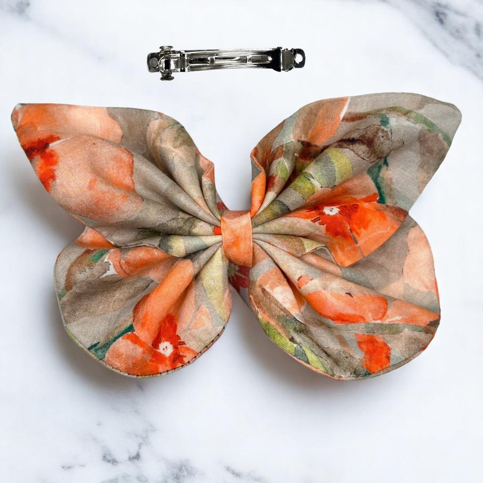 A vibrant Coral Bloom Floral Medium Cotton Butterfly Bow by Tuhil Threads, measuring approximately 12cm wide by 8cm high. Shop Tuhil Threads hair accessories.