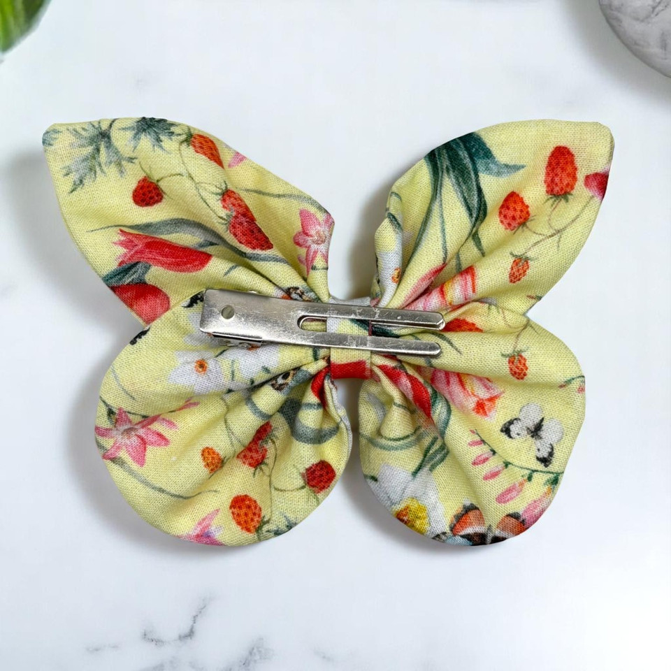 A cheerful Sunny Meadow Floral Medium Cotton Butterfly Bow by Tuhil Threads, measuring approximately 12cm wide by 8cm high. Shop Tuhil Threads hair accessories.