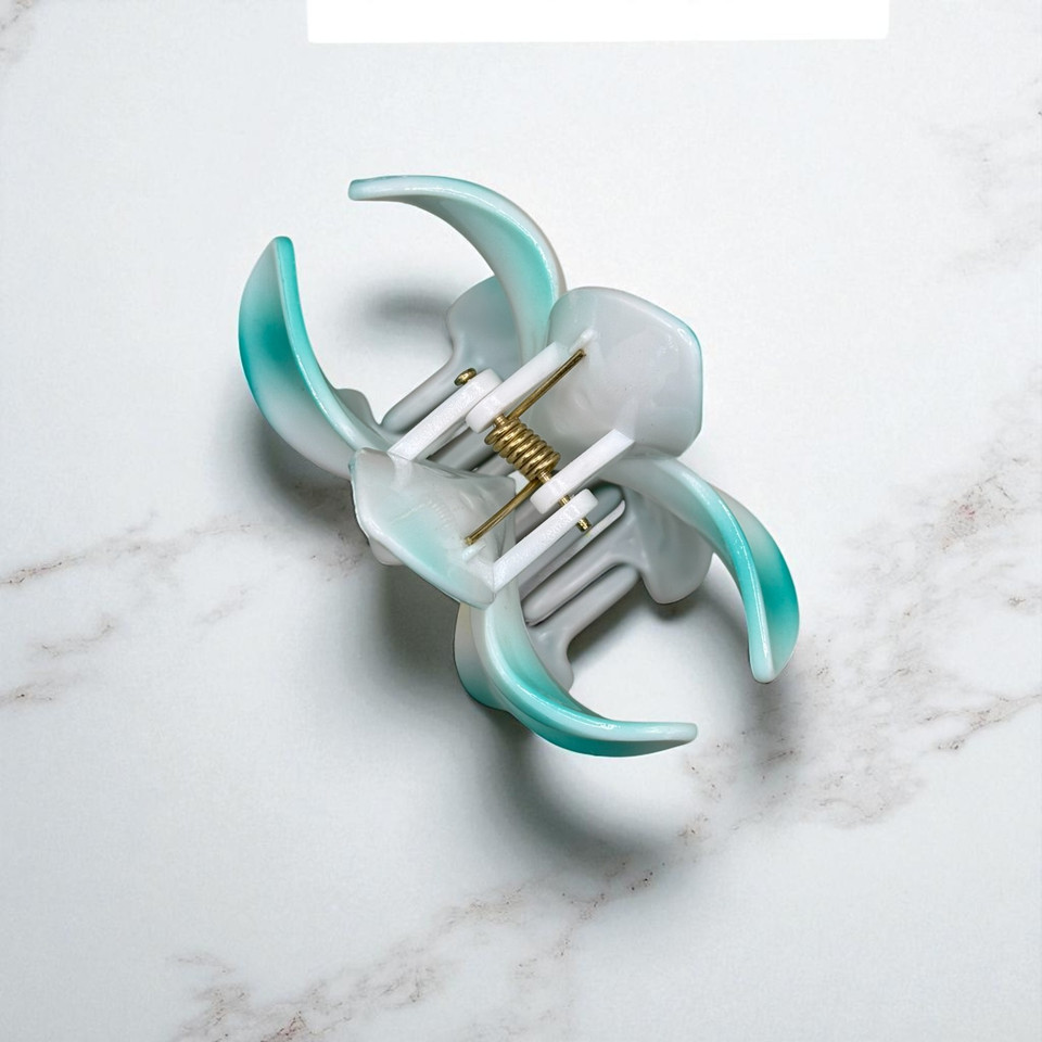 Detailed Side View of Blue Two-Tone Jelly Flower Hair Claw Clips displaying a metal clip. Detailed Side View of Blue Two-Tone Jelly Flower Hair Claw Clips displaying a metal clip.