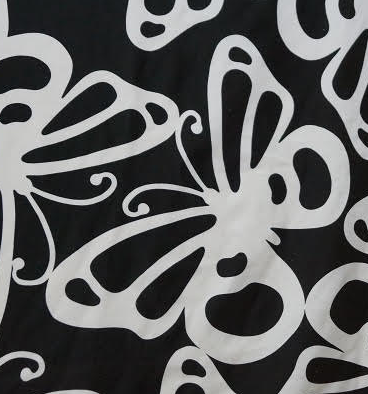 Black fabric with large white butterflies 