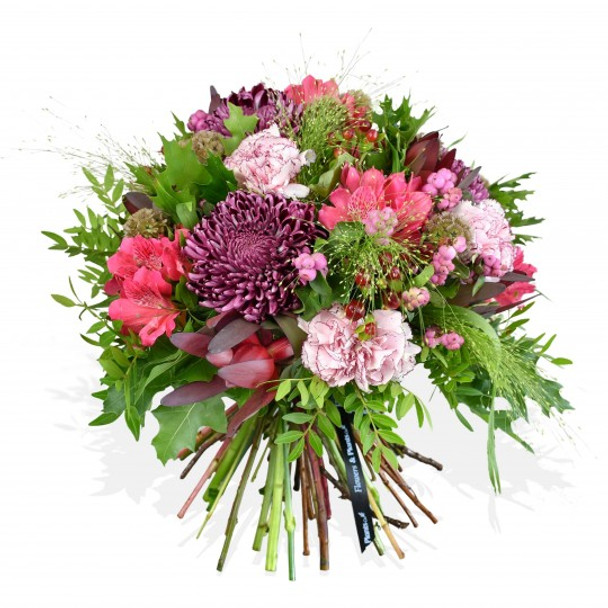 Purple bloom chrysanthemums and pink carnations are crafted with pink alstroemeria