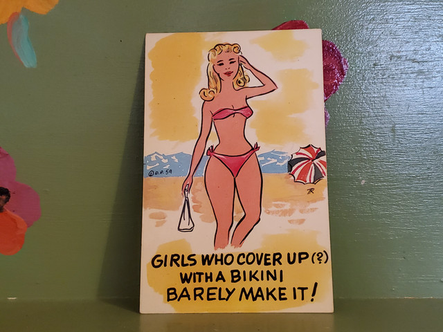 Pinup girls who cover up with a bikini barely make it postcard