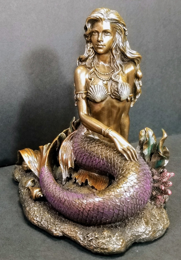 MERMAID SITTING ON THE OCEAN FLOOR