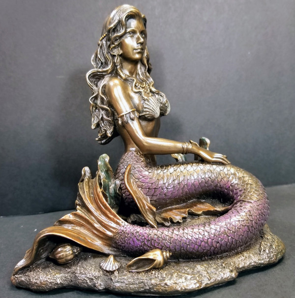 MERMAID SITTING ON THE OCEAN FLOOR