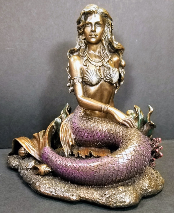 MERMAID SITTING ON THE OCEAN FLOOR