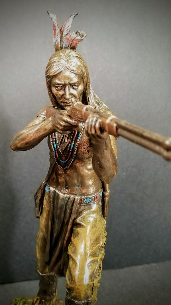 INDIAN WARRIOR STANDING AND SHOOTING RIFLE