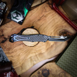 Heretic Knives  Hydra V4 Tanto DLC Full Carbon Fiber Chassis Hand Flamed Titanium Button Cover, Charge Plate And Pocket Clip.