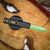 MICROTECH UTX-85 GEN IV D/E FULL SERRATED SERRATE JEDI MASTER W/GREEN BLADE, BRONZE HARDWARE, & BLACK CHASSIS 12324-3JM