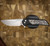 PROTECH KNIVES MORDAX, BLACK HANDLE, CASTED WHITE BRASS "USA 250TH" DESIGN, STONEWASH MAGNACUT BLADE, WHITE PEARL BUTTON, SERIALIZED OF 100 BSA26.MORDAX.2