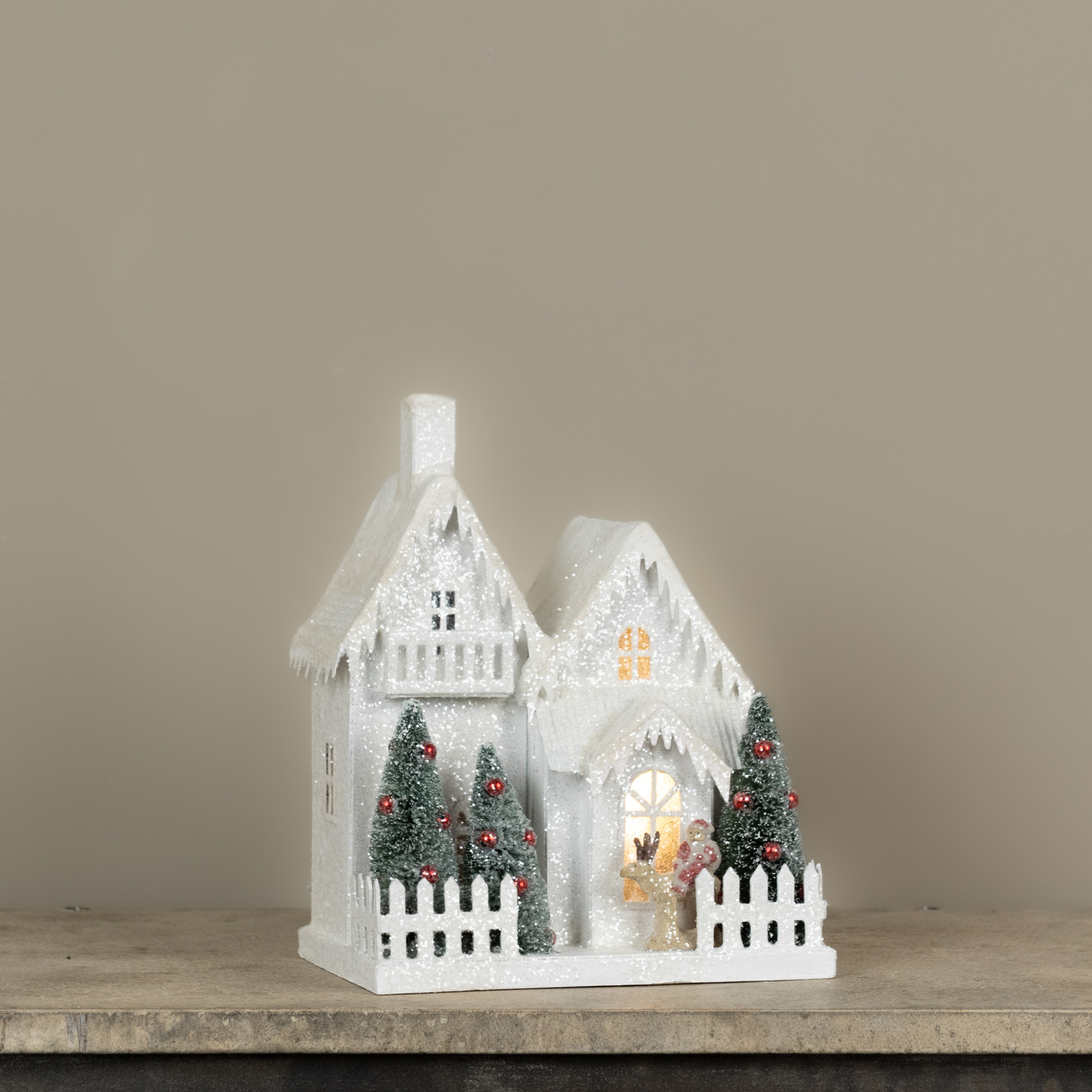 Lighted Snow-Covered House with Balcony