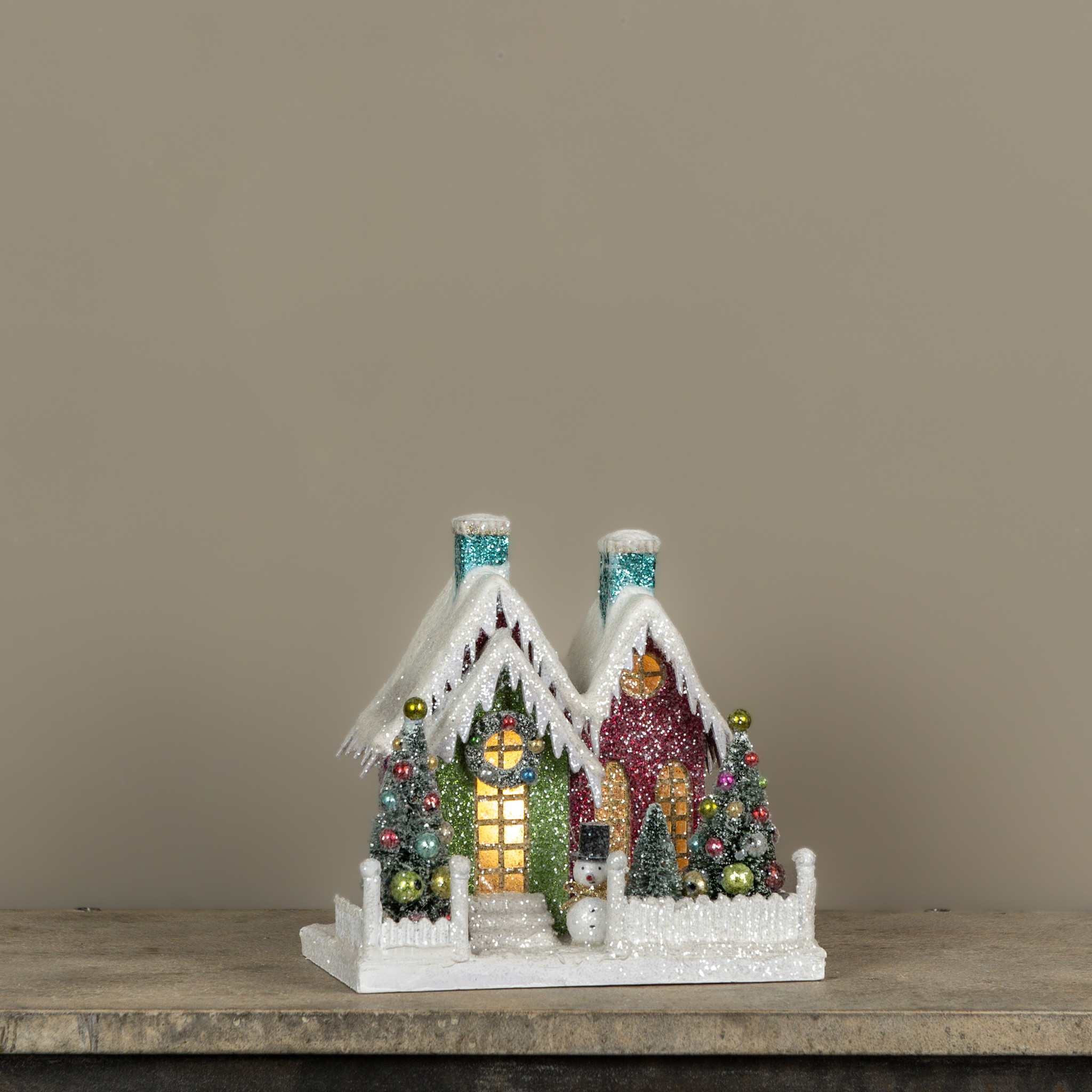 Lighted Colorful House with Two Teal Chimneys
