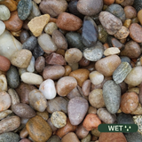 Close up photograph of Moray Pebble. When wet stones darken and become richer and more defined with a smooth, glossy look.