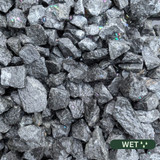 Close up photograph of Grey Whin. When wet, stones become a sleek, dark charcoal with a clean, modern aesthetic.