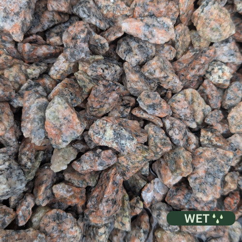 Close up photograph of Silver Granite. When wet, stones reveal intricate black flecks and a shimmering silver sheen.