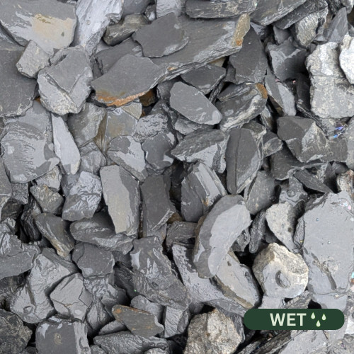 Close up photograph of  Charcoal Black Slate. When wet, stones transform into a deep, glossy midnight black that shines brilliantly in the rain.