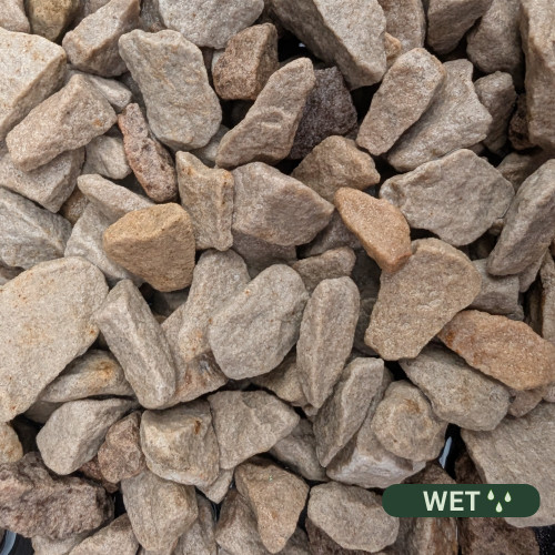 Close up photograph of Tuscany Buff. When Wet, stones shift to a deeper honey tone with smoother surface textures.