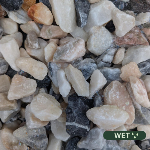 Close up photograph of Flamingo Chippings. When wet, stones turn into a vivid dusky rose and charcoal combination.