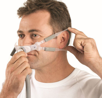 The ResMed Swift FX Bella Gray nasal pillow CPAP mask shown with its minimalist silicone headgear and soft nasal cushions