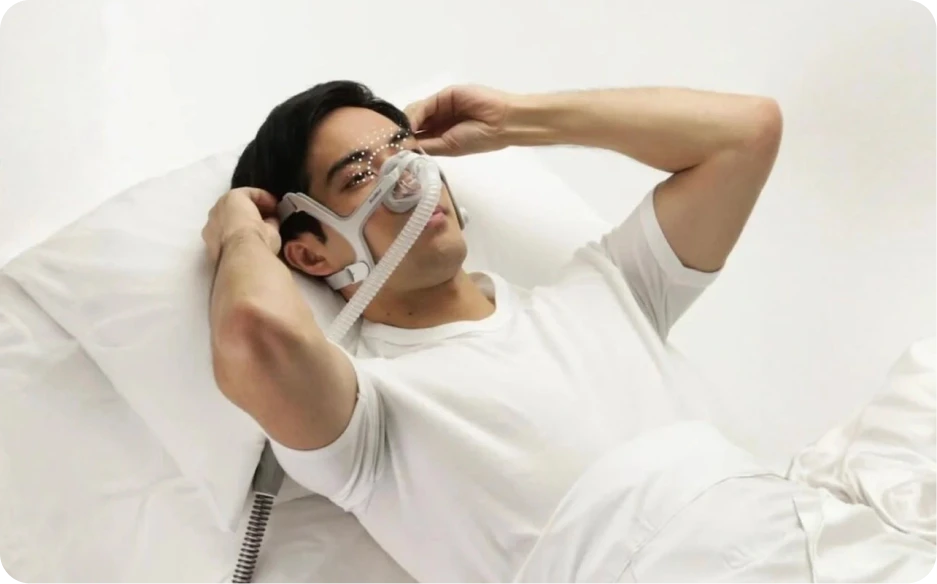 Person wearing CPAP mask in bed