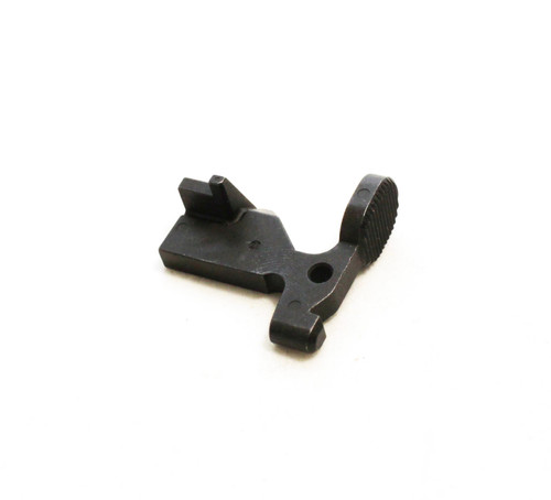 Top-down angled view of DSI black steel bolt catch for AR-15 rifles, precision machined for reliable bolt hold-open and release