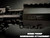 Exploded view of black MFR handguard detached from upper receiver showing chainlink tether, two retention pins, and barrel nut on dark background