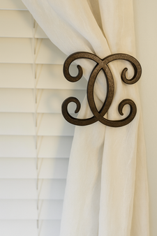 Interlocking scrolls drapery medallion 5-1/4″ square with a 3″ – 5″ projection.