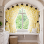 Daisy drapery medallion along an arched window.