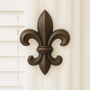 Fleur-di-lis drapery medallion 6-1/2" H x 5-1/2″ W with a 3″ – 5″ projection.