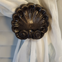 Traditional medium drapery medallion that can lend to the seashell side of your decor – 3-3/4″ diameter with a 3″ – 5″ diameter.