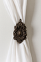 Traditional drapery medallion 6-3/4″ H x 4″ W with a 3″ – 5″ projection.